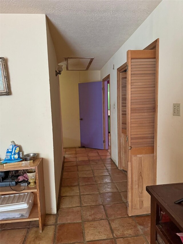 hallway with a textured ceiling