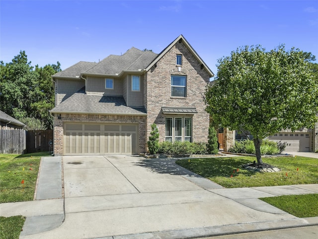 view of front of property featuring a front yard and a garage