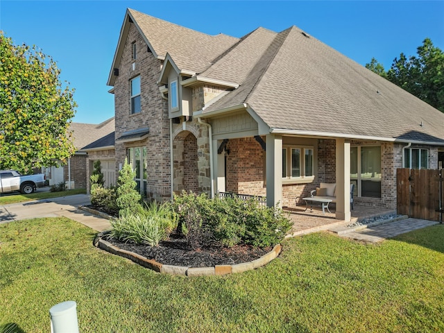 view of front of property with a porch and a front lawn