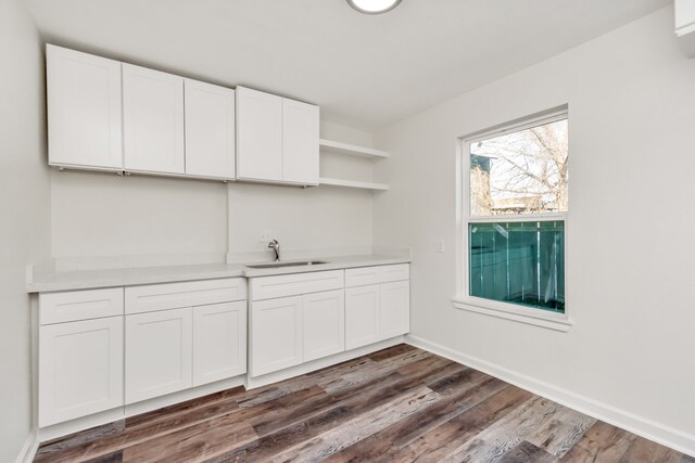 kitchen featuring sink, white cabinets, and dark hardwood / wood-style floors