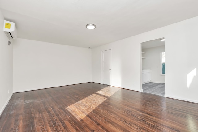 spare room featuring dark hardwood / wood-style flooring