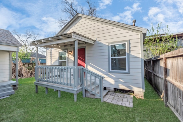 rear view of property with a lawn