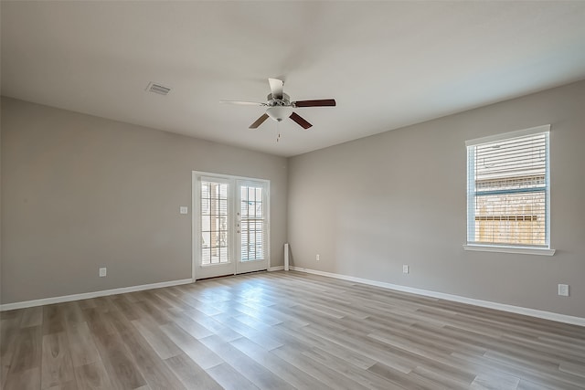 unfurnished room featuring french doors, light hardwood / wood-style flooring, and ceiling fan