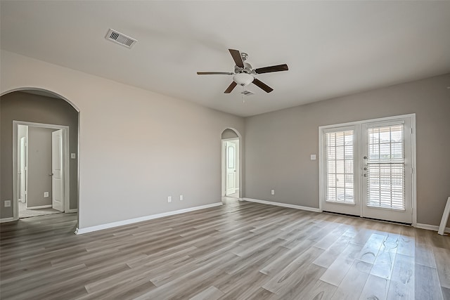 empty room featuring ceiling fan and light hardwood / wood-style flooring