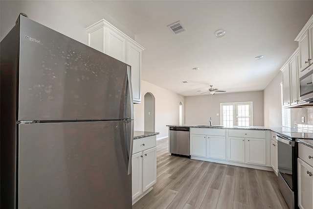 kitchen featuring sink, white cabinets, light wood-type flooring, appliances with stainless steel finishes, and ceiling fan