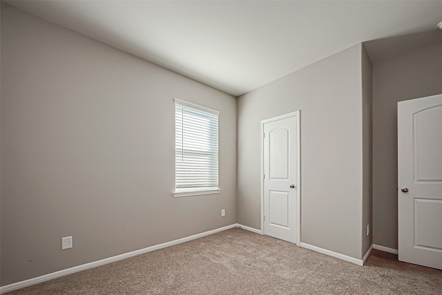 unfurnished bedroom featuring light colored carpet