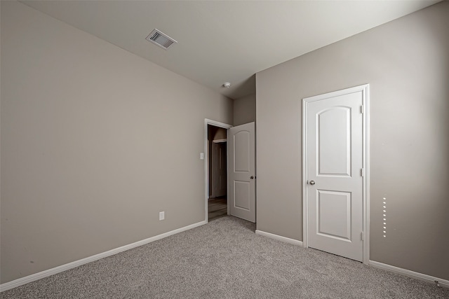 unfurnished bedroom with light colored carpet