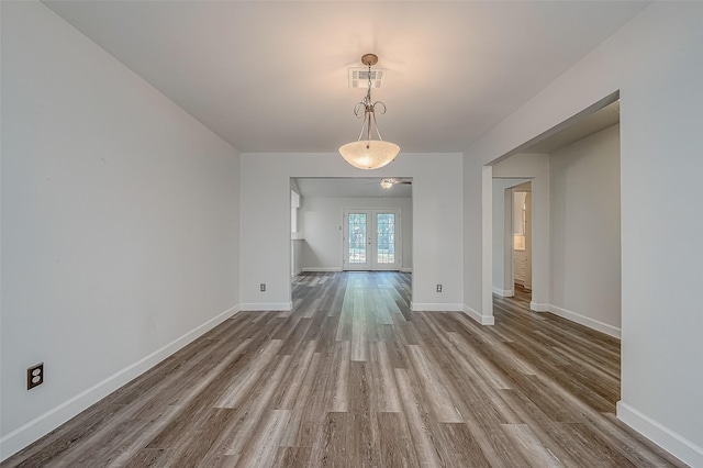 unfurnished dining area with french doors and hardwood / wood-style floors