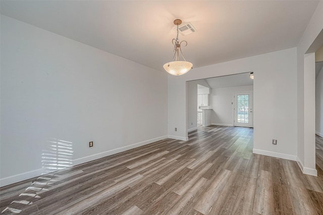 spare room with hardwood / wood-style floors and ceiling fan