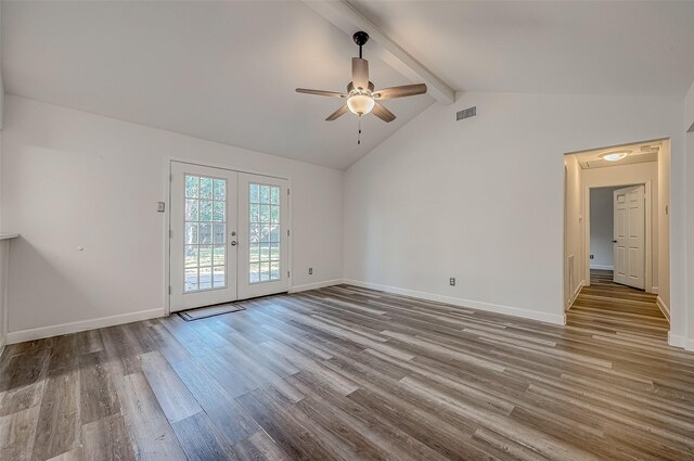 spare room with lofted ceiling with beams, ceiling fan, french doors, and light hardwood / wood-style flooring