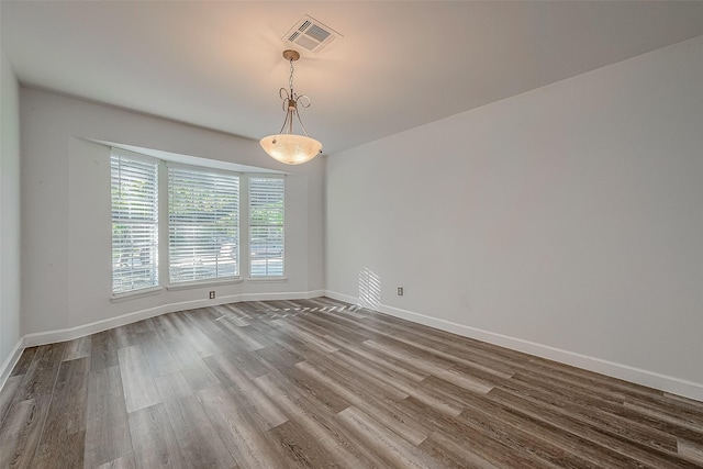 unfurnished room with wood-type flooring