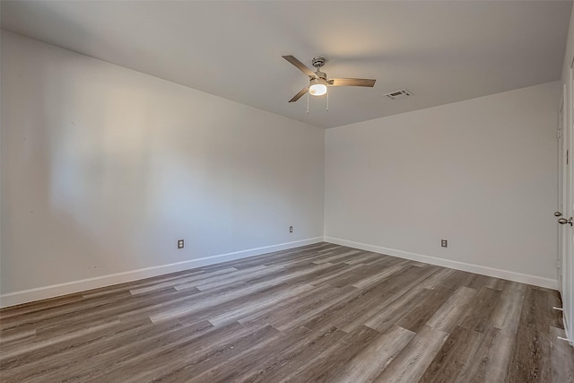 empty room with hardwood / wood-style floors and ceiling fan