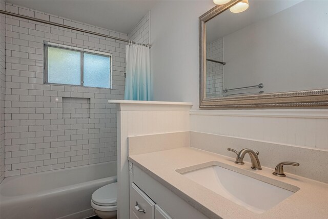 full bathroom featuring vanity, toilet, and shower / tub combo with curtain