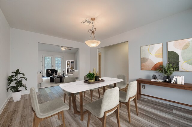 dining area with ceiling fan, french doors, and hardwood / wood-style floors