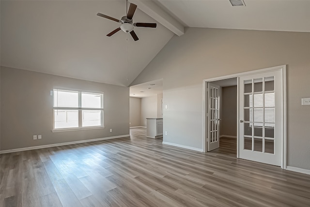 unfurnished living room featuring beam ceiling, high vaulted ceiling, light hardwood / wood-style floors, and ceiling fan