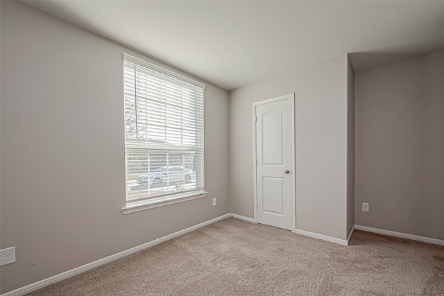 unfurnished bedroom with multiple windows and light colored carpet