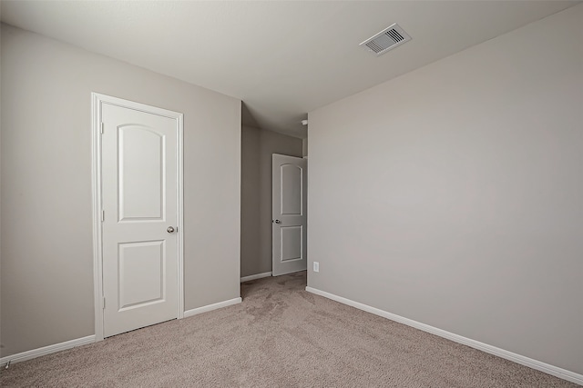 spare room with light colored carpet