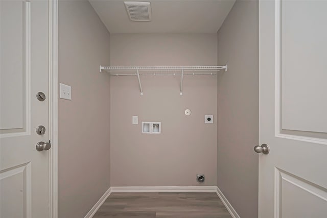 laundry room featuring electric dryer hookup, washer hookup, light hardwood / wood-style flooring, and hookup for a gas dryer