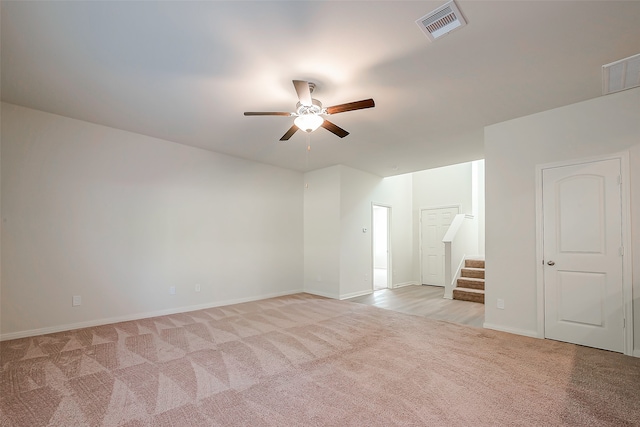 empty room featuring light carpet and ceiling fan