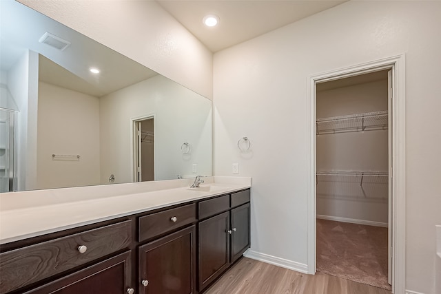 bathroom with vanity and hardwood / wood-style flooring