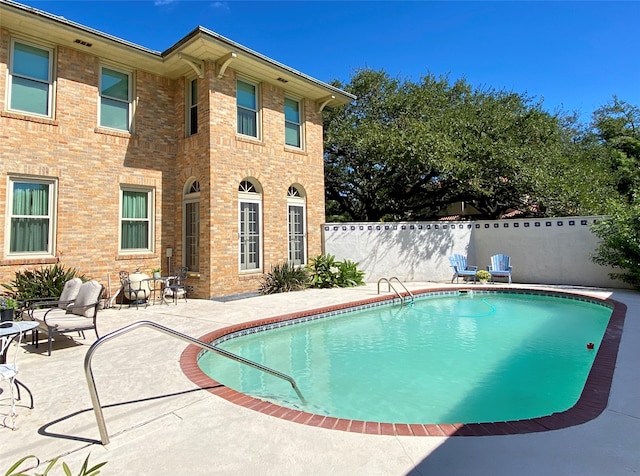 view of swimming pool with a patio