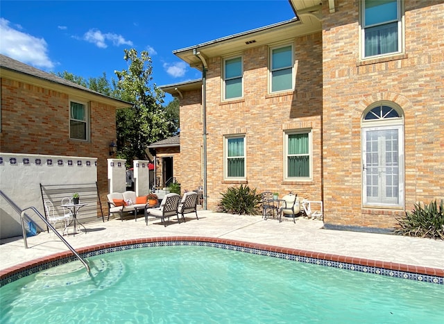 back of property featuring an outdoor living space and a patio area