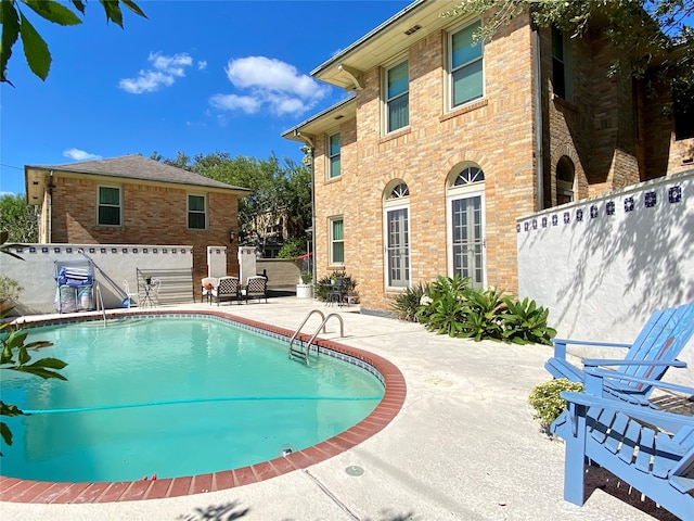 view of swimming pool featuring a patio area