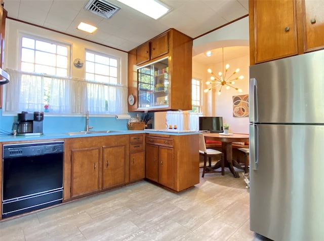 kitchen with kitchen peninsula, stainless steel fridge, black dishwasher, a chandelier, and sink