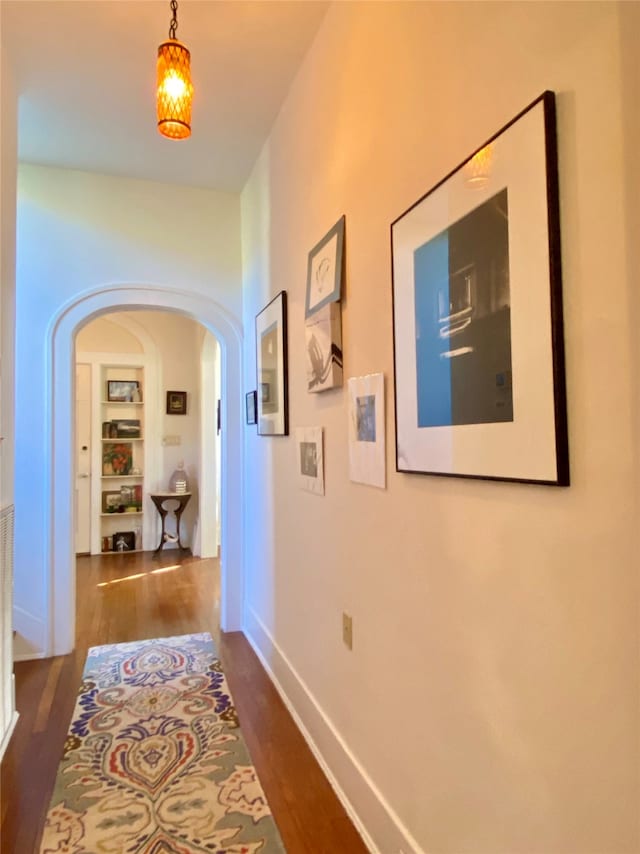 hall with dark hardwood / wood-style flooring