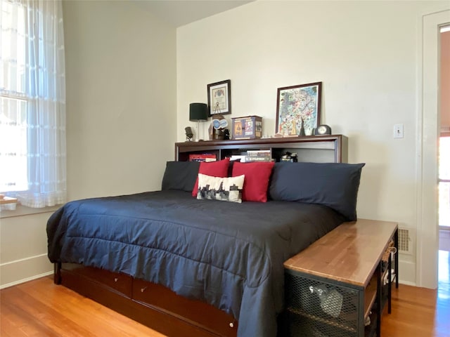 bedroom with hardwood / wood-style flooring