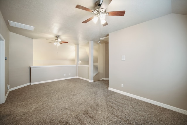 carpeted spare room with vaulted ceiling and ceiling fan