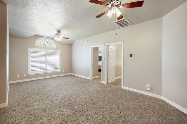 carpeted empty room with lofted ceiling, a textured ceiling, and ceiling fan