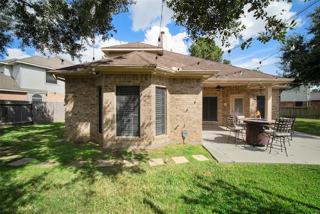 back of property featuring a patio and a lawn