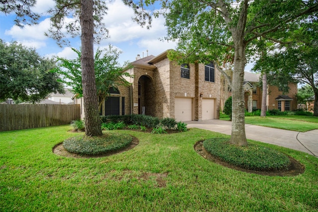 view of front of house featuring a garage and a front lawn