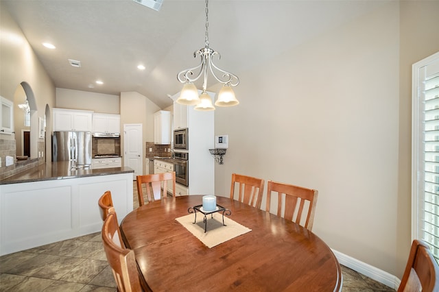 dining space featuring a notable chandelier, high vaulted ceiling, and plenty of natural light