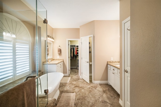 bathroom with vanity and a washtub