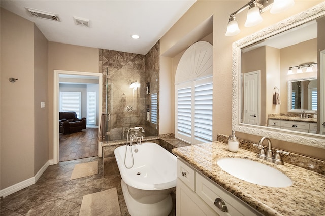 bathroom featuring vanity, shower with separate bathtub, a healthy amount of sunlight, and tile patterned flooring