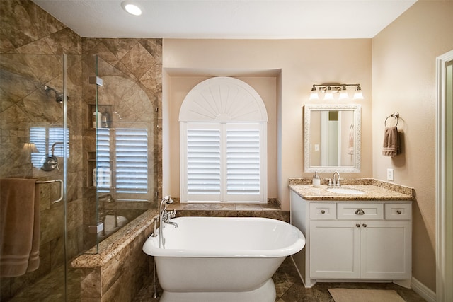 bathroom featuring vanity and shower with separate bathtub