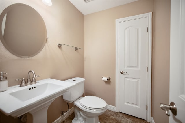 bathroom with tile patterned floors, sink, and toilet