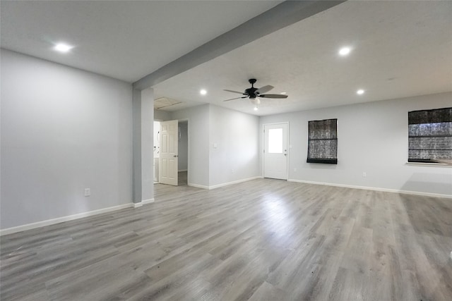 unfurnished living room with light wood-type flooring and ceiling fan