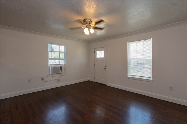 interior space with dark wood-type flooring, crown molding, and a textured ceiling