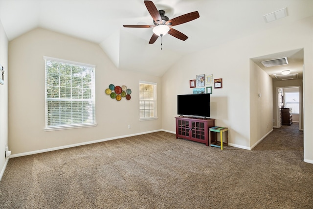 unfurnished living room with vaulted ceiling, carpet floors, and a healthy amount of sunlight