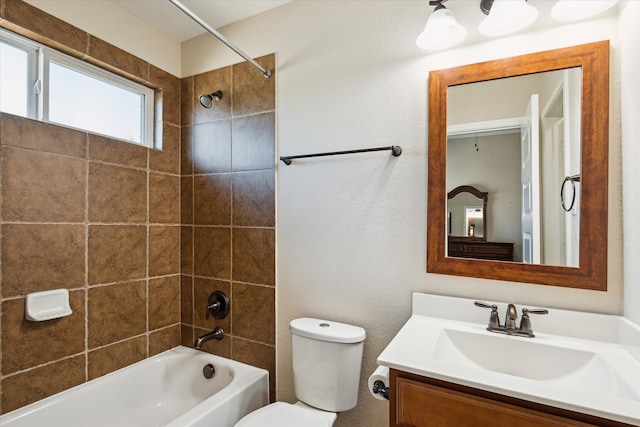 full bathroom with vanity, toilet, and tiled shower / bath combo