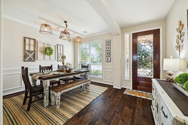 dining room with crown molding and dark hardwood / wood-style floors