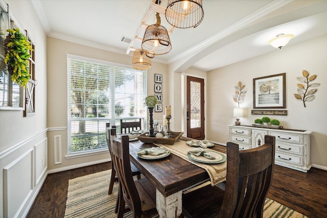 dining area featuring crown molding, plenty of natural light, and dark hardwood / wood-style floors