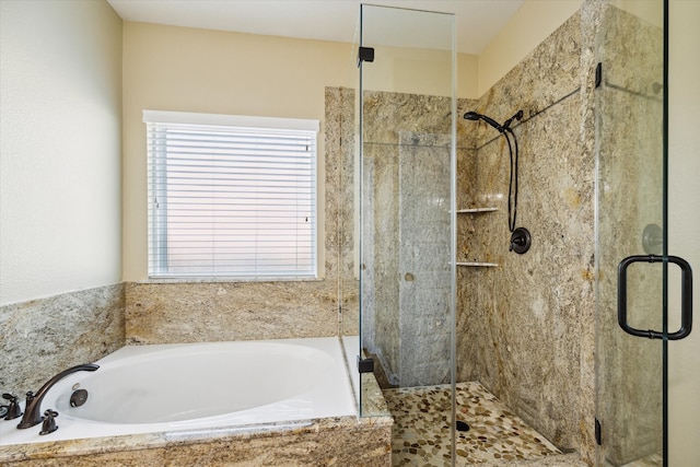 bathroom featuring separate shower and tub