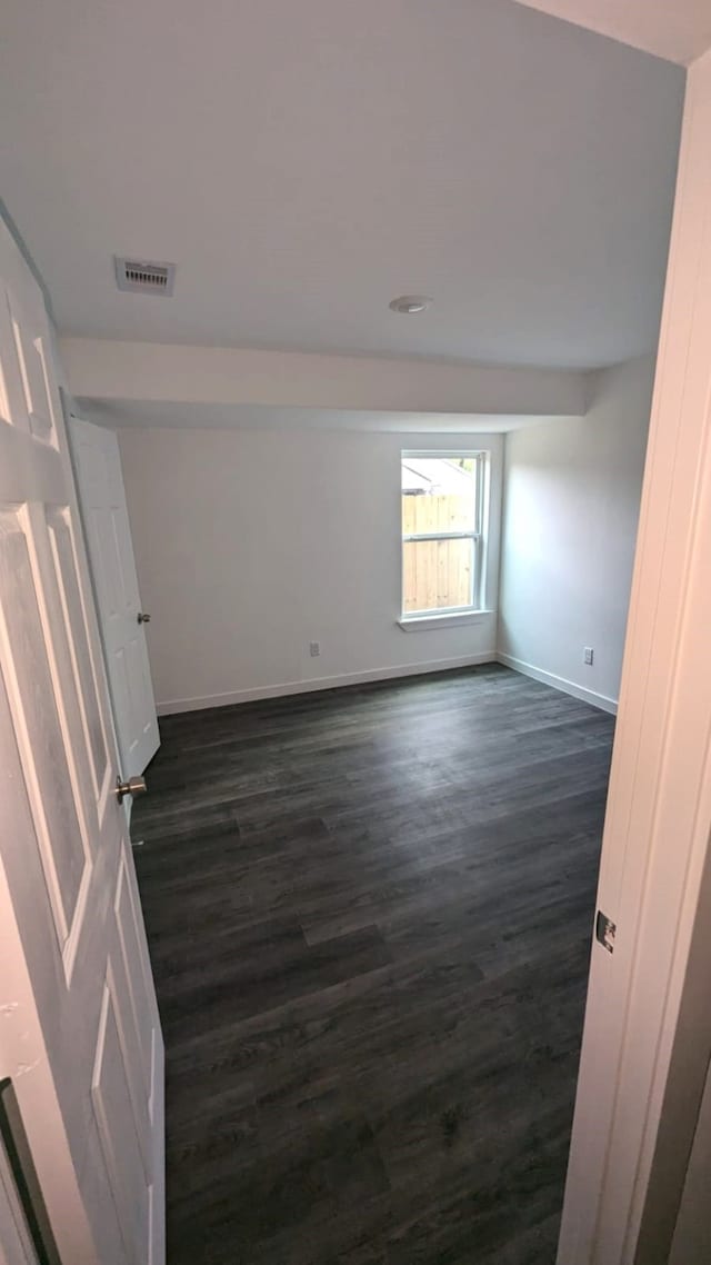 spare room featuring dark hardwood / wood-style floors