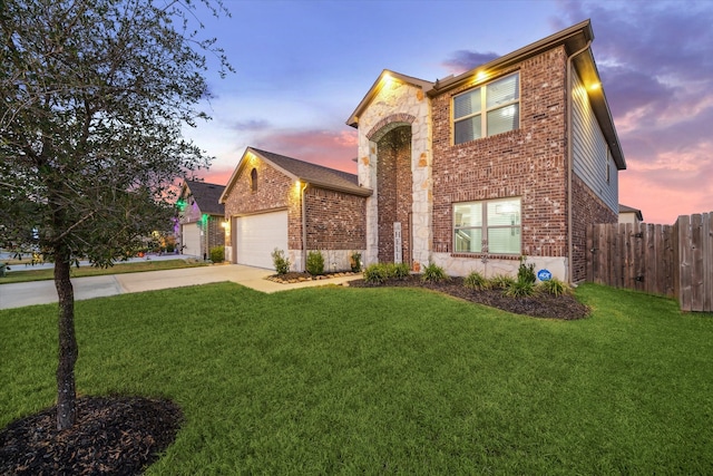 view of front of house featuring a garage and a lawn