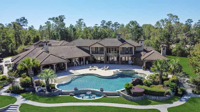 view of swimming pool with an in ground hot tub, a patio area, and a lawn