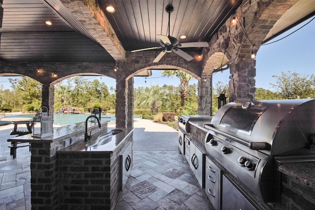 27918 Hansons Ct, Spring, TX 77386 - view of patio / terrace with exterior kitchen, a ceiling fan, a grill, an outdoor pool, and washer / clothes dryer